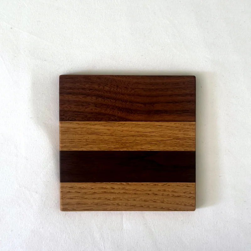 A striped coaster in oak and walnut