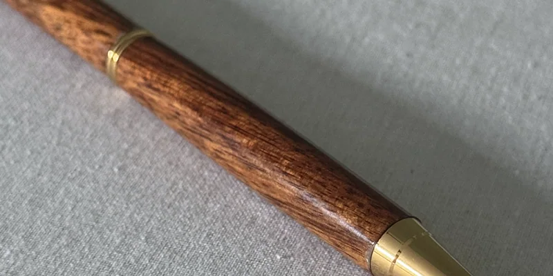 Close-up of a hand-turned pen in Sapele