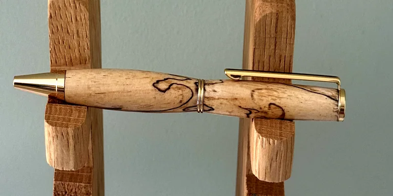 A hand-turned ballpoint pen in Spalted Tamarind