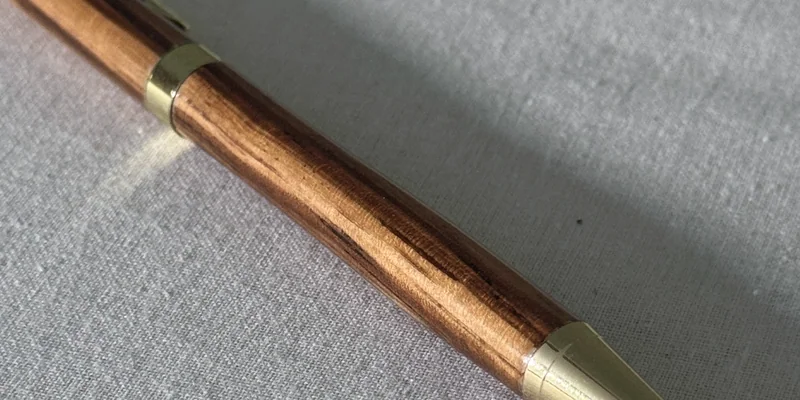 Close-up of a hand-turned pen in Zebrano